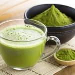 Close-up of vibrant green tea matcha tea powder in a traditional bamboo scoop.