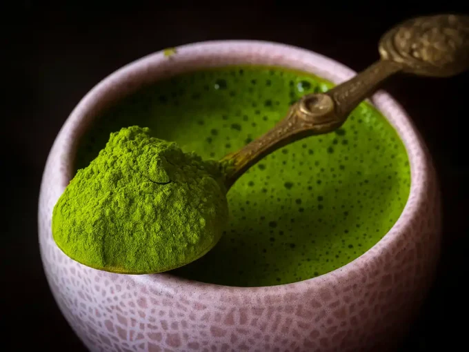 Whisking matcha powder in a bowl to unlock Matcha Tea Benefits naturally.