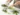 Step-by-step image showing whisking matcha powder in a bowl for Iced Matcha Coconut Water preparation.